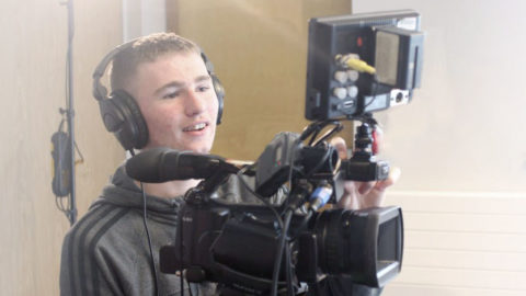 Young man operating the camera