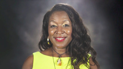 Portrait of smiling woman in yellow top