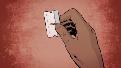 A hand holding a blade