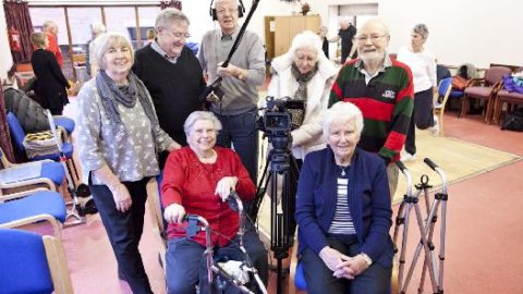 Group of older campaigners with camera equipment